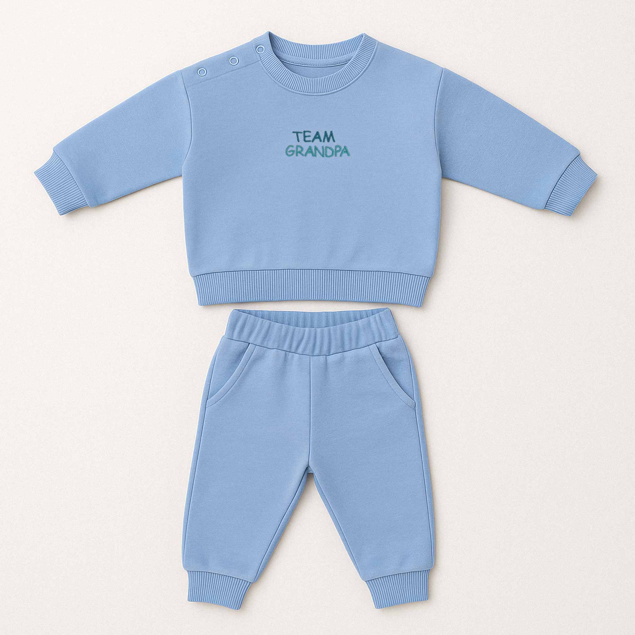 Mavi renkli, sweatshirt ve pantolondan oluşan "Team Grandpa" nakışlı, omuzdan çıtçıtlı pamuklu bebek eşofman takımı.