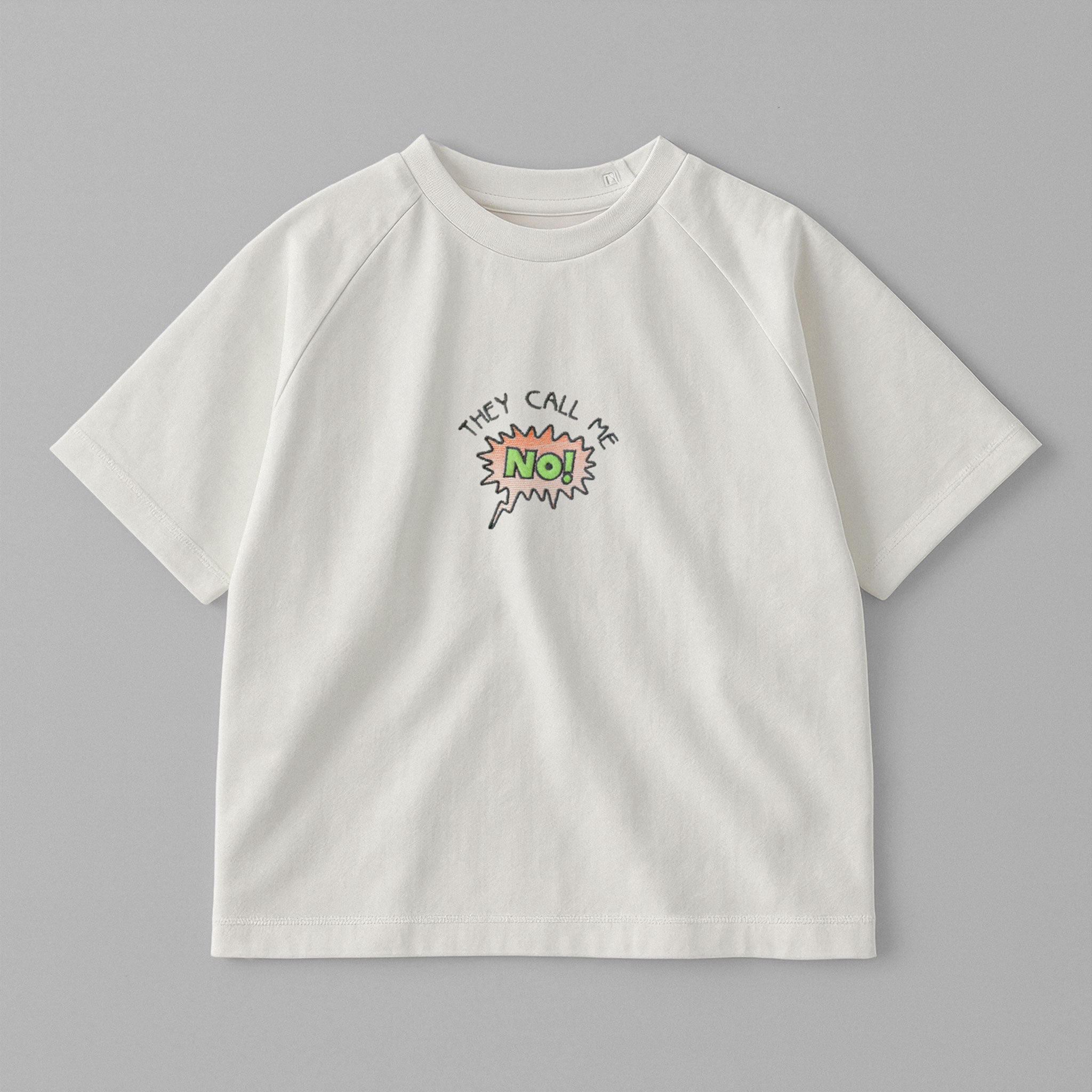 Ekru renkli, reglan kollu, omuzdan çıtçıtlı bebek tişörtü. Göğüs kısmında çizgi roman stilinde "THEY CALL ME NO!" nakışı bulunmaktadır.