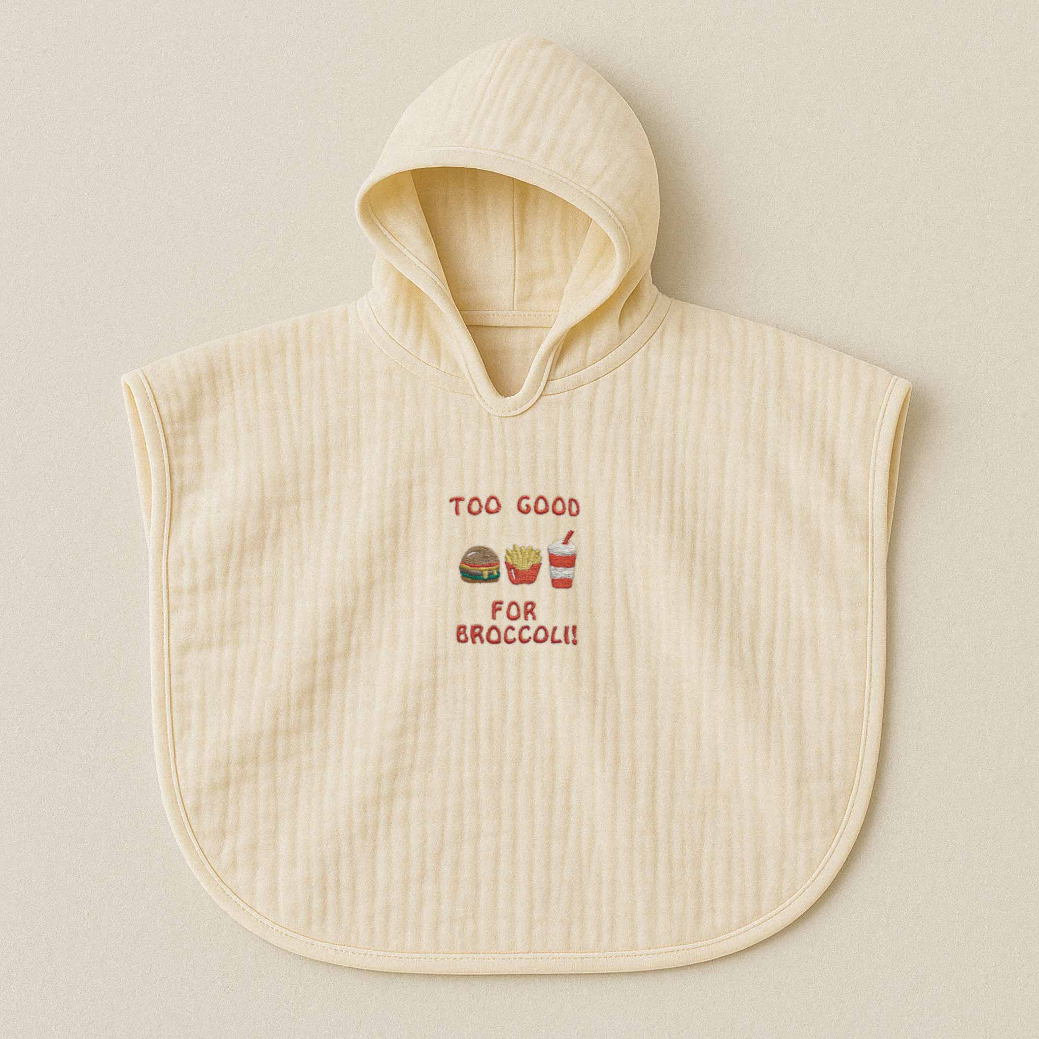 Ekru (doğal bej) renginde, kapüşonlu, müslin kumaştan bebek ve çocuk pançosu. Göğüs kısmında "Too Good for Broccoli" yazısı ve hamburger, patates kızartması, içecek nakışları bulunmaktadır.